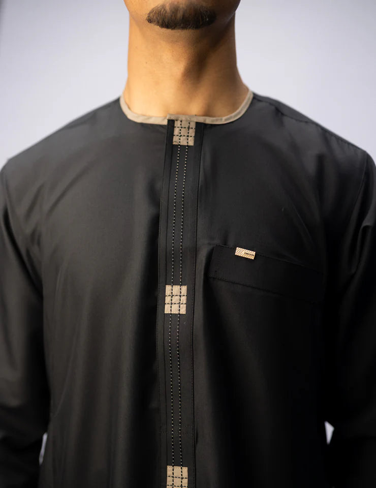 Amaani Dune Kids Thobe in black, front view of the collarless thobe with placket detail