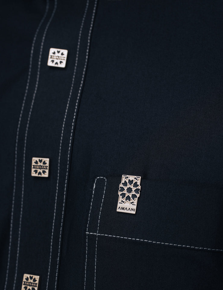 Amaani Royal Thobe in black, signature buttons and contrast stitching down the placket