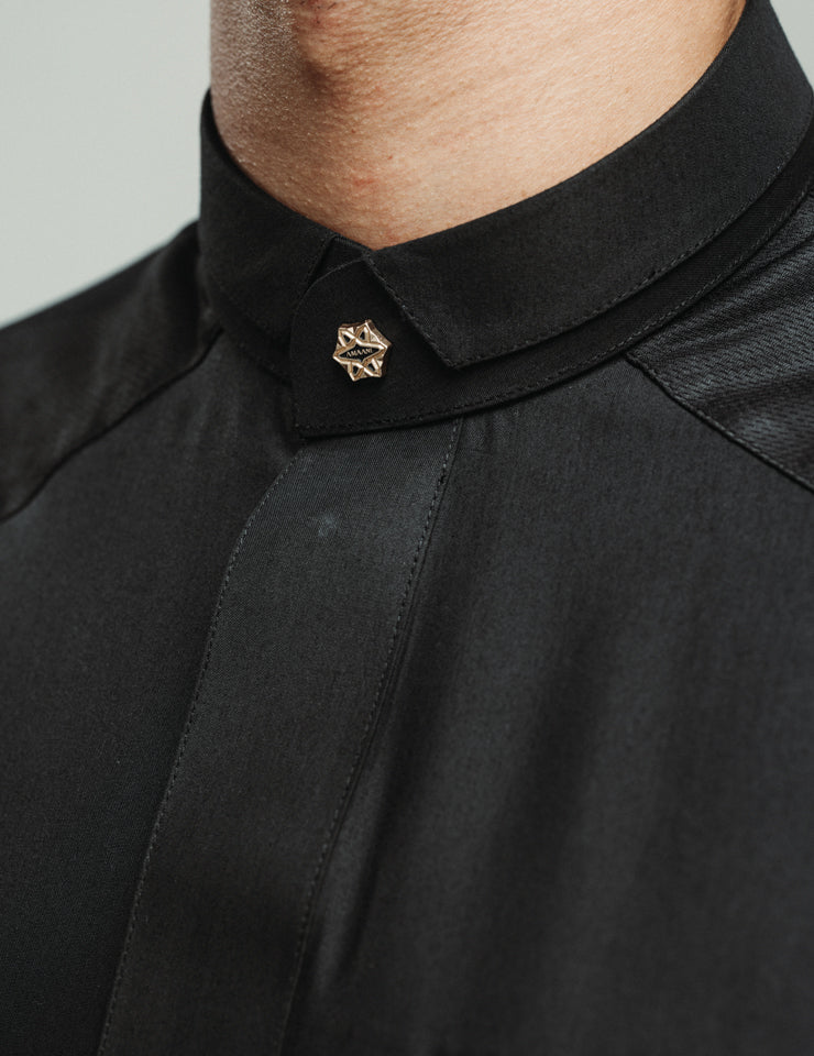 Detail of the black Amaani Stark kids thobe showing cuff patterning and signature buttons