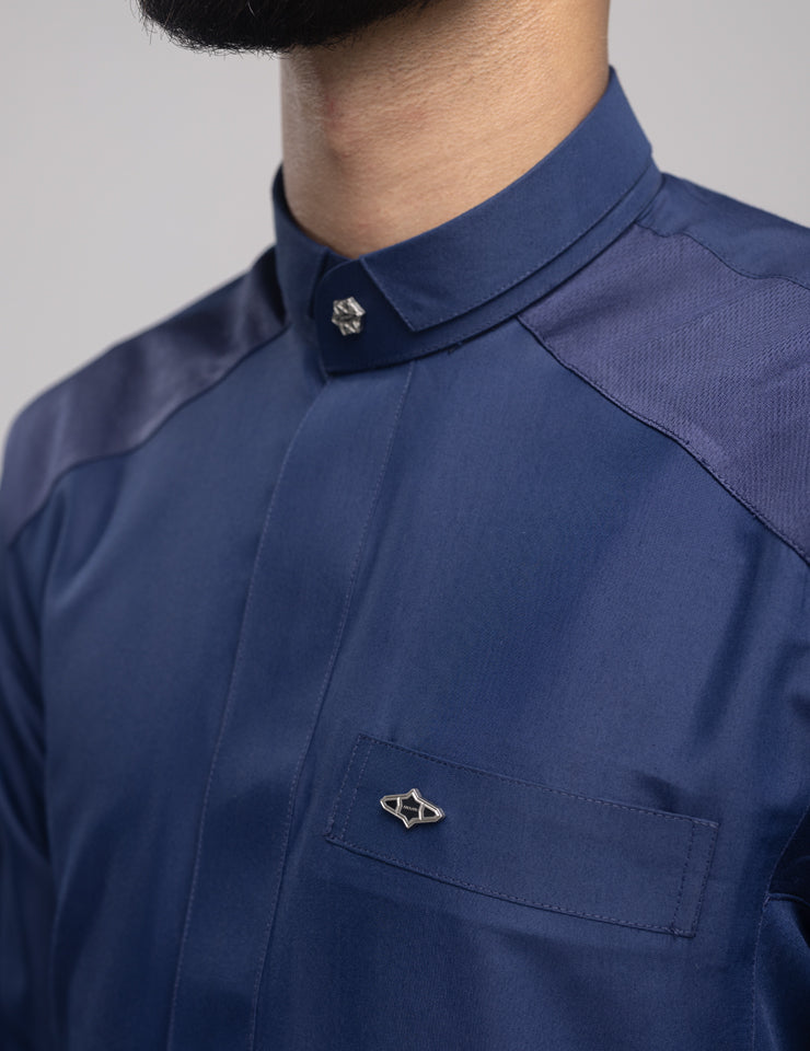 Detail of the navy Amaani Stark kids thobe, intricate shoulder and cuff patterning