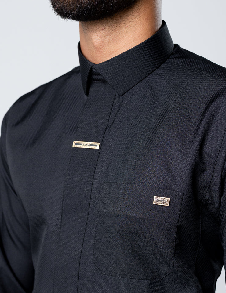 Second placket detail view with signature Amaani buttons on the black Amaani Fakhama thobe