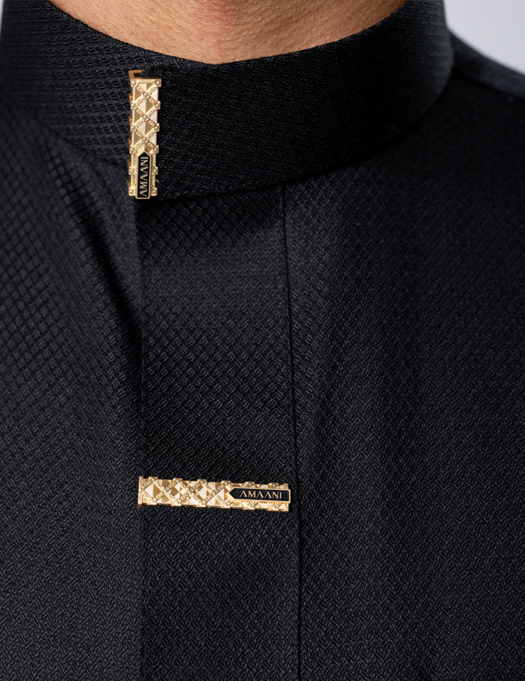 Textured weave detail on the black Amaani Nibras Saudi Thobe with signature buttons